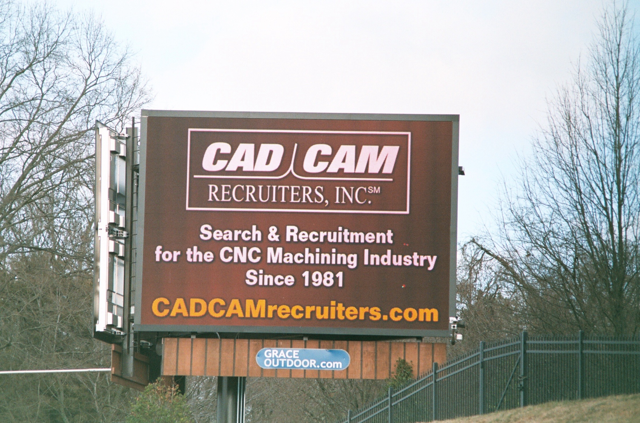 Billboard for CAD CAM Recruiters, highlighting their services in CNC machining recruitment since 1981. Website displayed for more information.