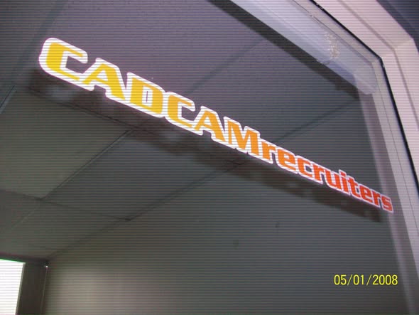 "Sign for CADCAM Recruiters displayed on a glass door, indicating a recruitment service focused on CAD and CAM industries."