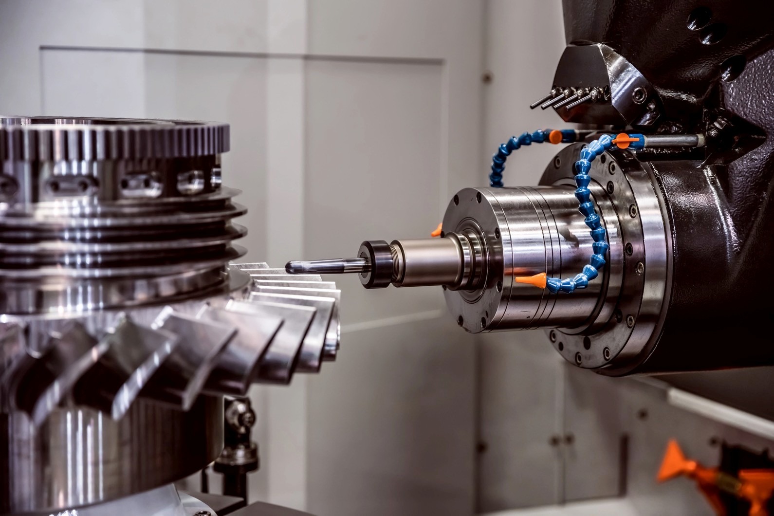 Precision machining process showcasing a CNC machine tool working on a metal component. The setup highlights advanced manufacturing technology.